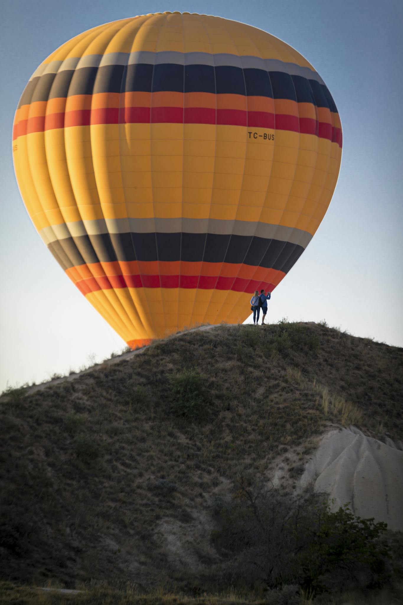 Colorful hot air balloon above hill